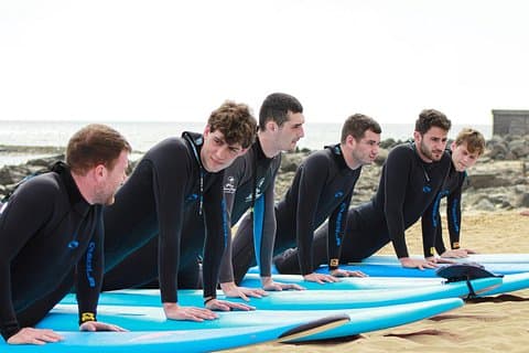 Surf training on the beach – warm up before surfing in Gran Canaria