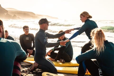 Surf instructor explains the stand-up technique