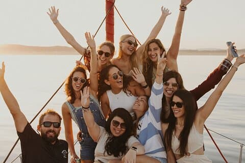 Group of friends sailboat rental in Sotogrande with Assol at sunset on sailboat