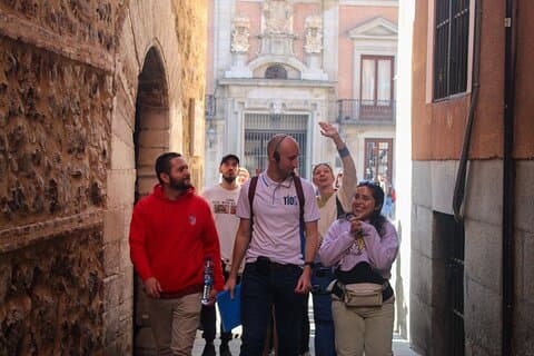 Inquisitive guests walking along one of Madrid's narrow medieval streets.