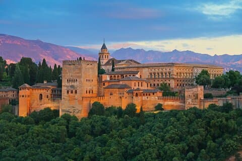 A magical sunset over the Alhambra, illuminating its ancient walls with golden hues.