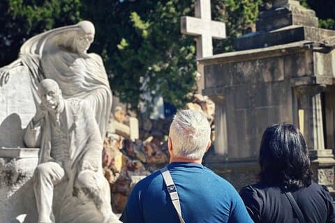 Guests on the monjtuic cemetery tour in barcelona admiring one of the stunning graves