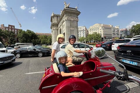 Front-row seats to history. A father-son duo taking in the sights at Puerta de Alcalá on our private, guided sidecar expedition.