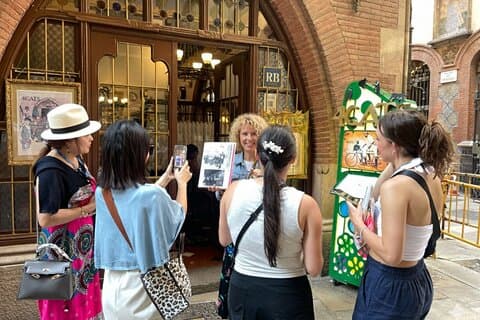 Guests exploring the historic entrance of a hidden art spot in Barcelona.