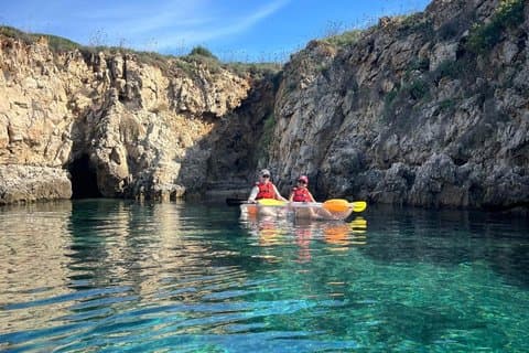 Guided tour in transparent kayaks of Addaia Bay