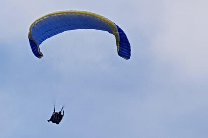 paragliding at the mountains with hotel pickup