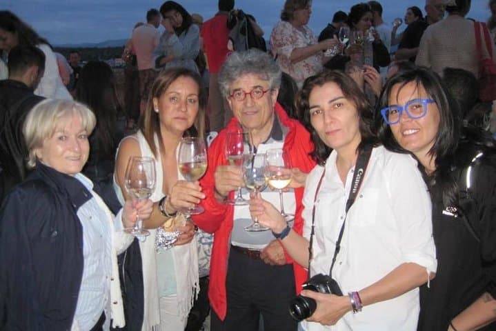 Toasting with a white wine in a "fiesta" of a medieval town