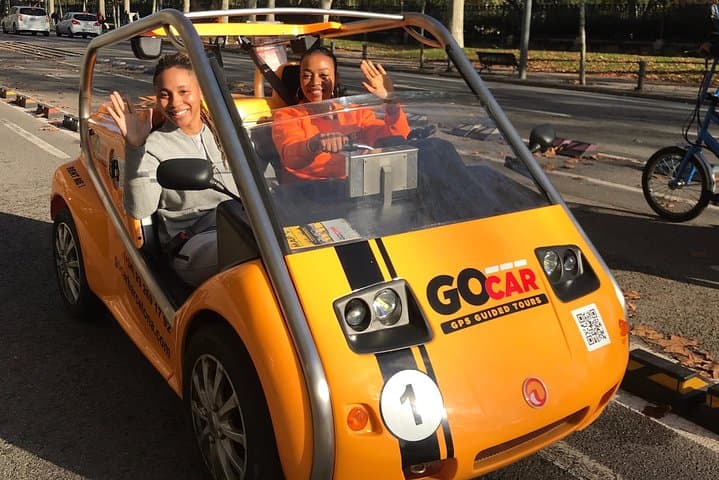 American customers departing on a GPS guided tour with the electric GoCar in the streets of Barcelona
