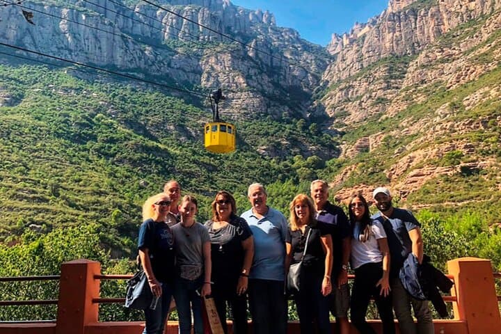 Private tour guests at Montserrat with cable car and mountains