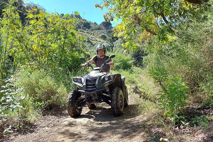 Riding quad over hills and crossing rivers