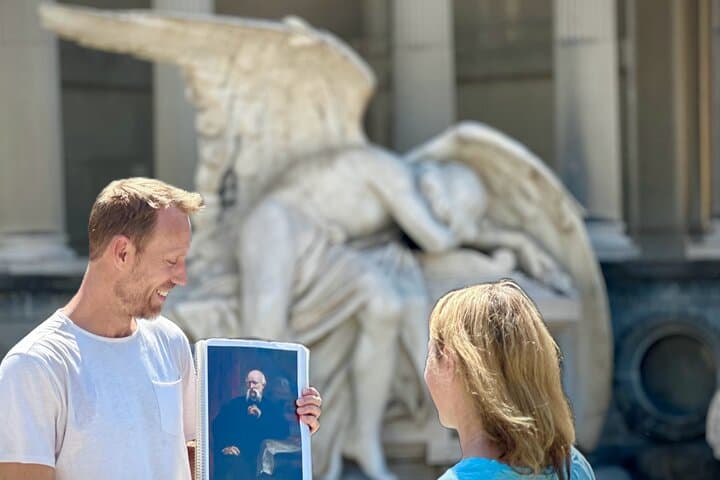 Montjuic cemetery tour guide explaining about one of the angel graves