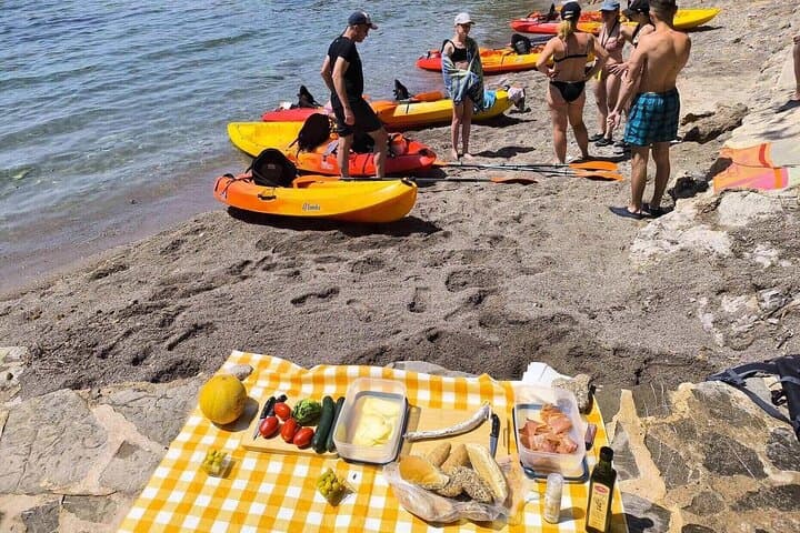 Picnic with local produce. (Bread, cheese, tomato, olives, cucumber, lettuce, fruit, ham, sausage)