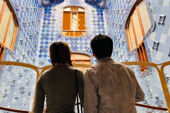 Visitors admire Casa Batlló's lightwell and tile work