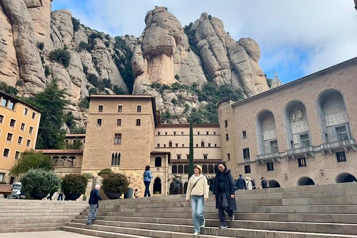 Visitors walking in front of the Basilica of Montserrat