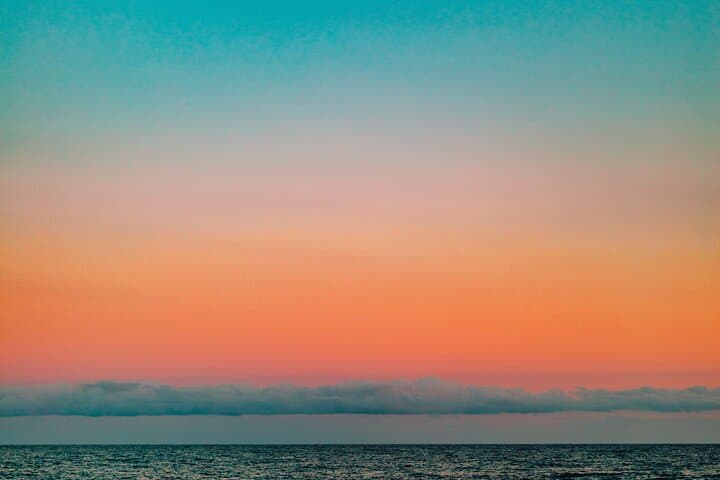 Colorful sunset sky with full moon outside