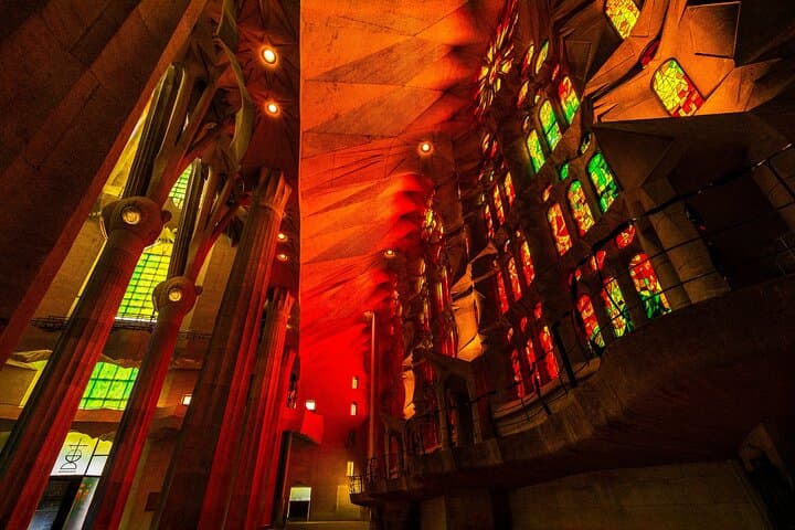 As the sun sets, the Sagrada Família transforms into a glowing sanctuary of fiery reds and golds—a mesmerizing spectacle reserved for those who linger a little longer.