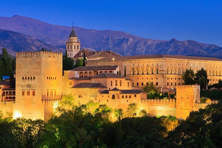A mesmerizing view of Alhambra’s Nasrid Palaces, showcasing exquisite tilework and elegant archways.