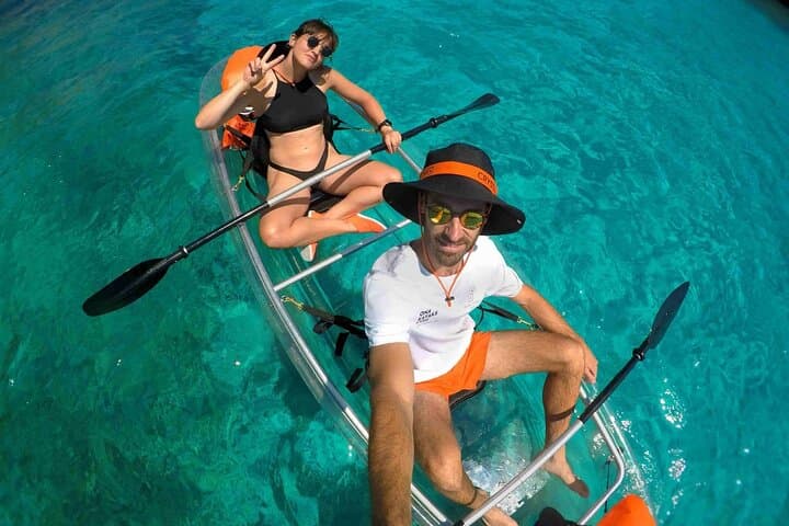 Guided tour in transparent kayaks of Addaia Bay