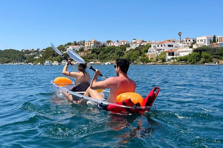 Guided tour in transparent kayaks of Addaia Bay