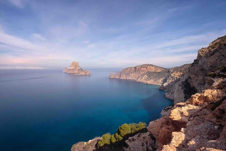 Peaceful daytime view of Es Vedrà and the calm Mediterranean Sea