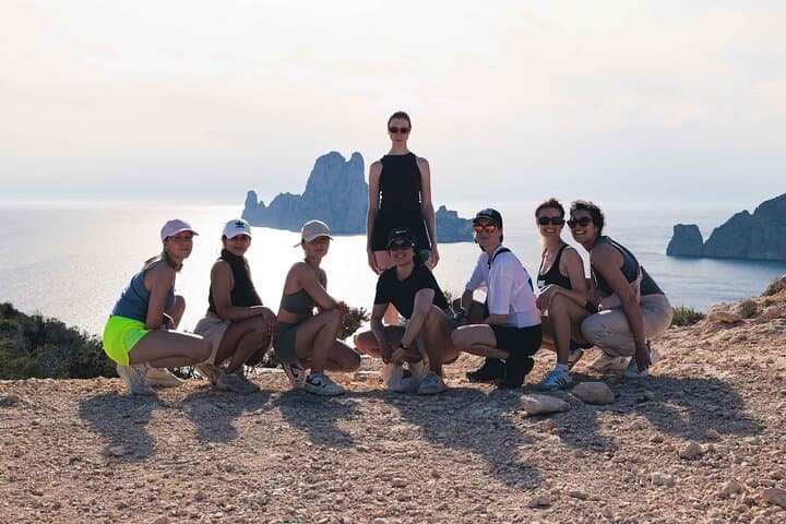 Group of friends enjoying the moment with Es Vedrà in the background