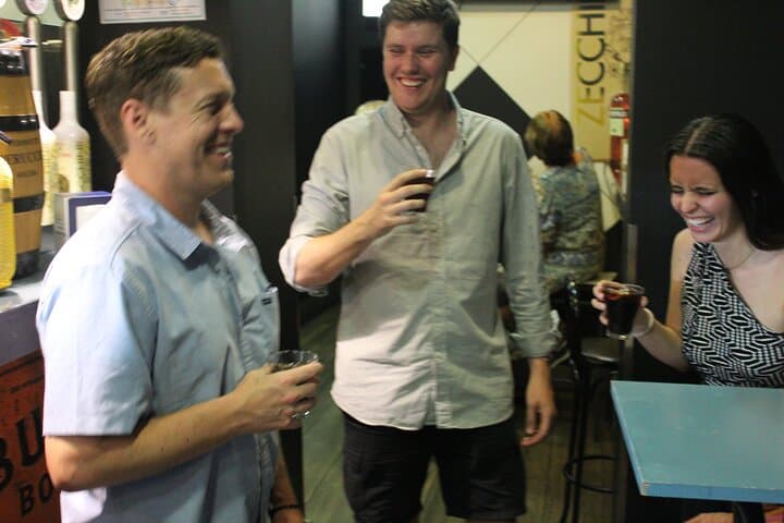 Guests enjoying a laugh over a glass of delicious vermouth