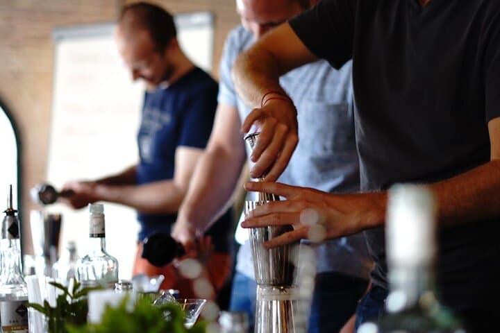 Guests learning to prepare traditional sangria and creative cocktails in a fun workshop in Barcelona.