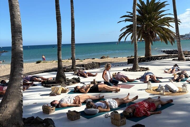 Yoga with headphones in front of the sea in Lanzarote