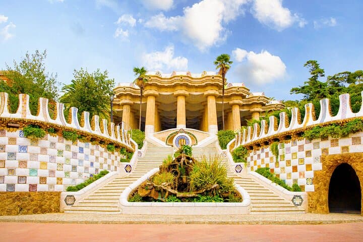 The grand staircase and columns of Park Güell offer a stunning entry to Gaudí’s architectural masterpiece.