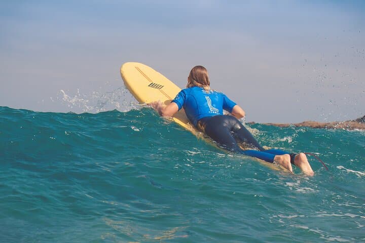 Paddle past the last wave to reach the line-up and catch green waves.