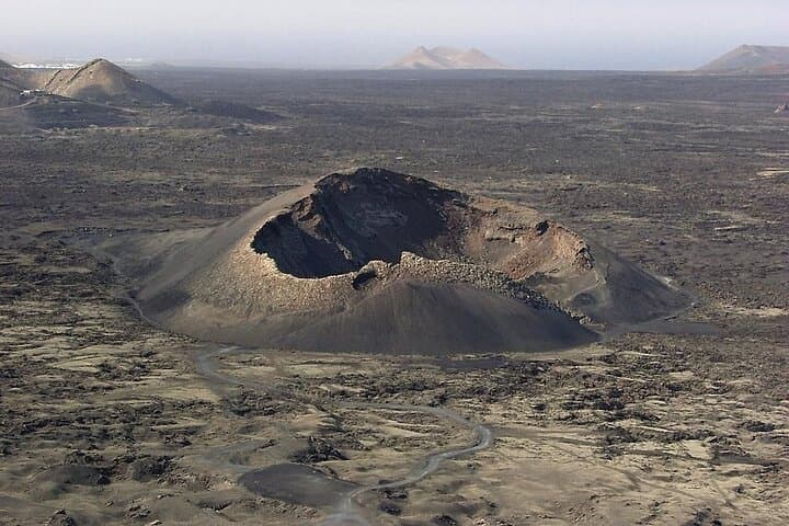 Walk to the interior of the Cuervo volcano, origin of the Timanfaya national park, an impressive crater, a truly magnetic place where you can feel the force of nature with every step.