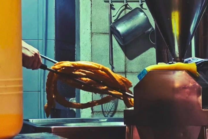 Traditional churros being freshly prepared in a local café