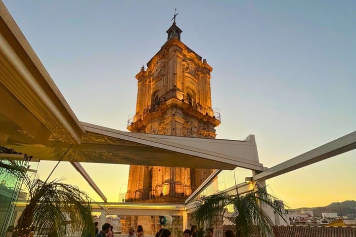 Sunset rooftop views over Málaga Cathedral during the walking tour experience.