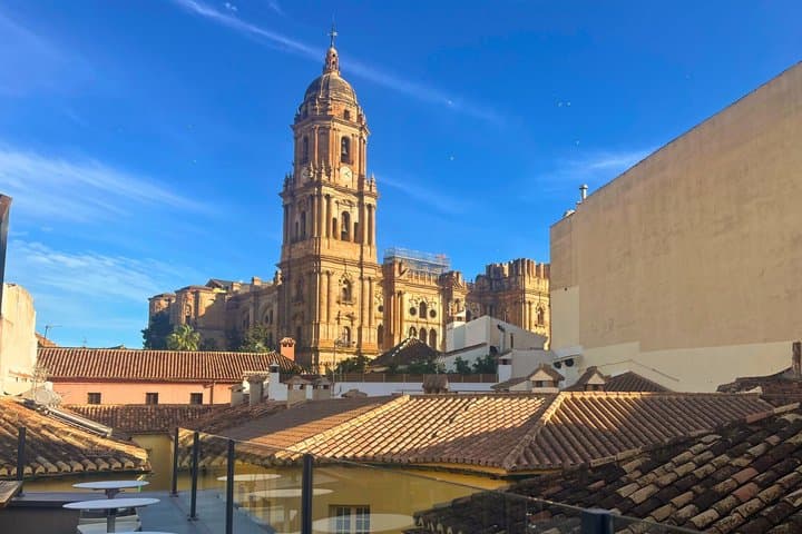 Panoramic view of Málaga Cathedral from one of the selected rooftop terraces.