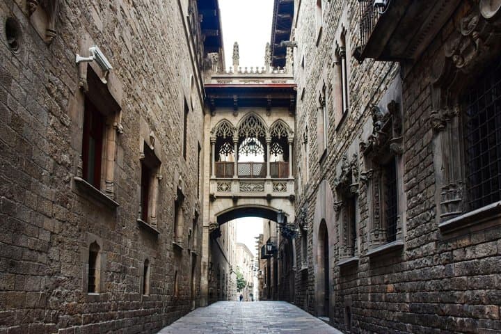 The Pont del Bisbe looks medieval but was built in the 20th century. This neo-Gothic bridge reflects Barcelona’s desire to shape its past. Look for the skull beneath the arch.