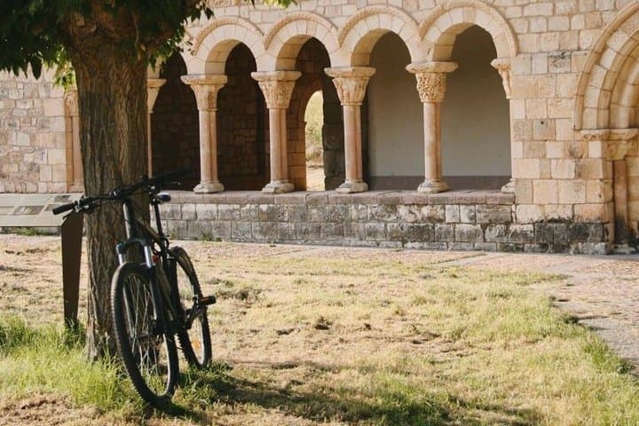 Our bike resting next to the Romanesque cloister of the church of the Assumption of Duraton, a few kilometers from Sepulveda.