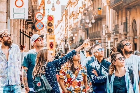This is Jana introducing Barcelona to one of our small groups of guests. She's standing on Plaça Sant Jaume, pointing at the Generalitat de Catalunya with Carrer de Ferran in the background.