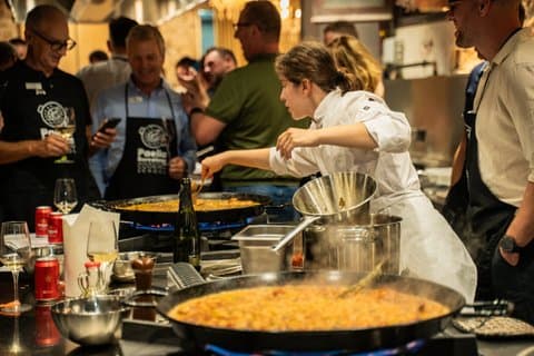 Masterclass in action! Chef Maria skillfully manages two large 60cm paellas simultaneously while teaching our participants—showing the true scale of our hands-on cooking experience.