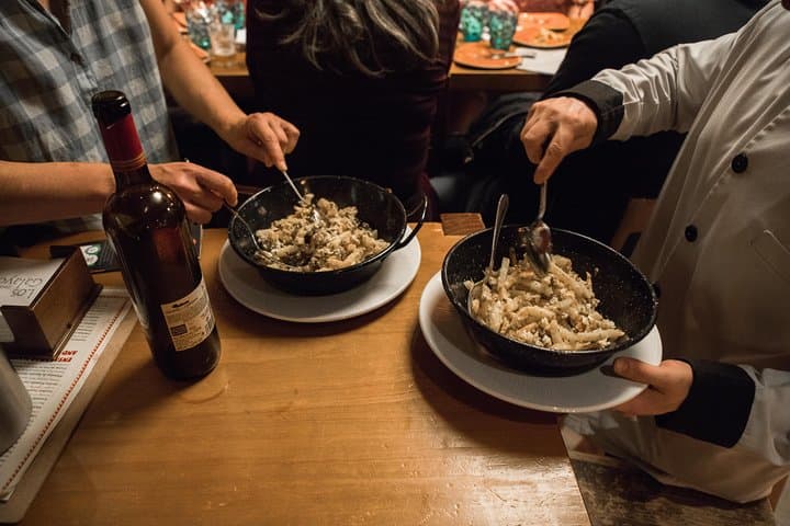 Chef demonstrates the art of making tapas on a food tasting tour.