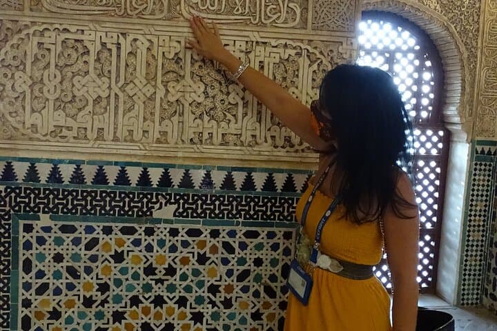 Showing the calligraphy in the walls of the Alhambra.