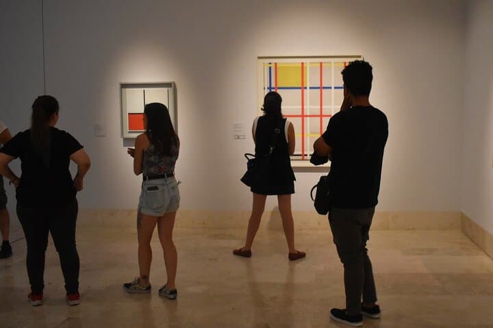 Visitors contemplate pictures at the Thyssen Museum.