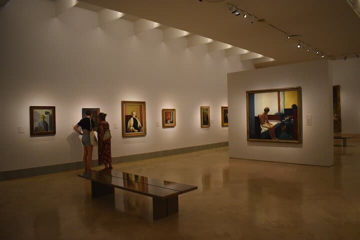 Visitors contemplate pictures at the Thyssen Museum.