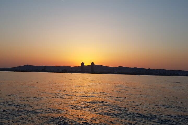 Sunset on a Sailboat along the Coast of Barcelona