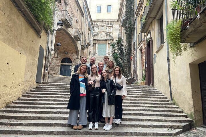 Visitors gathered on historic stairs in Girona with a guide