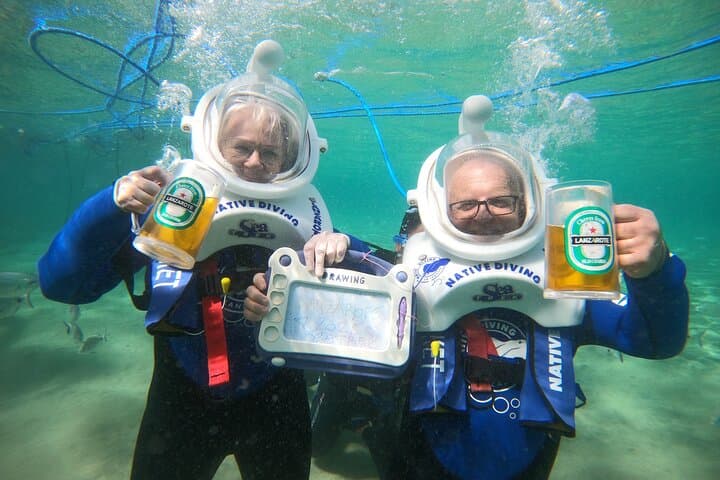 Senior couple enjoying a peaceful and safe Sea Trek underwater walk—no swimming skills needed.