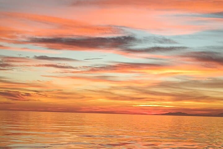 Sailing at sunset along the cliffs of Maro-Compartida