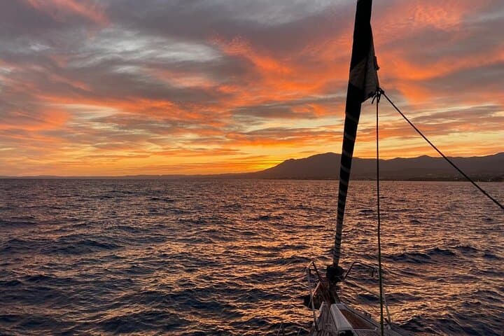 Sailing at sunset along the cliffs of Maro-Compartida
