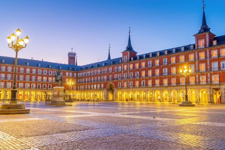 Plaza Mayor: The beating heart of the city at dusk, famous for its arcades and statue of Philip III.